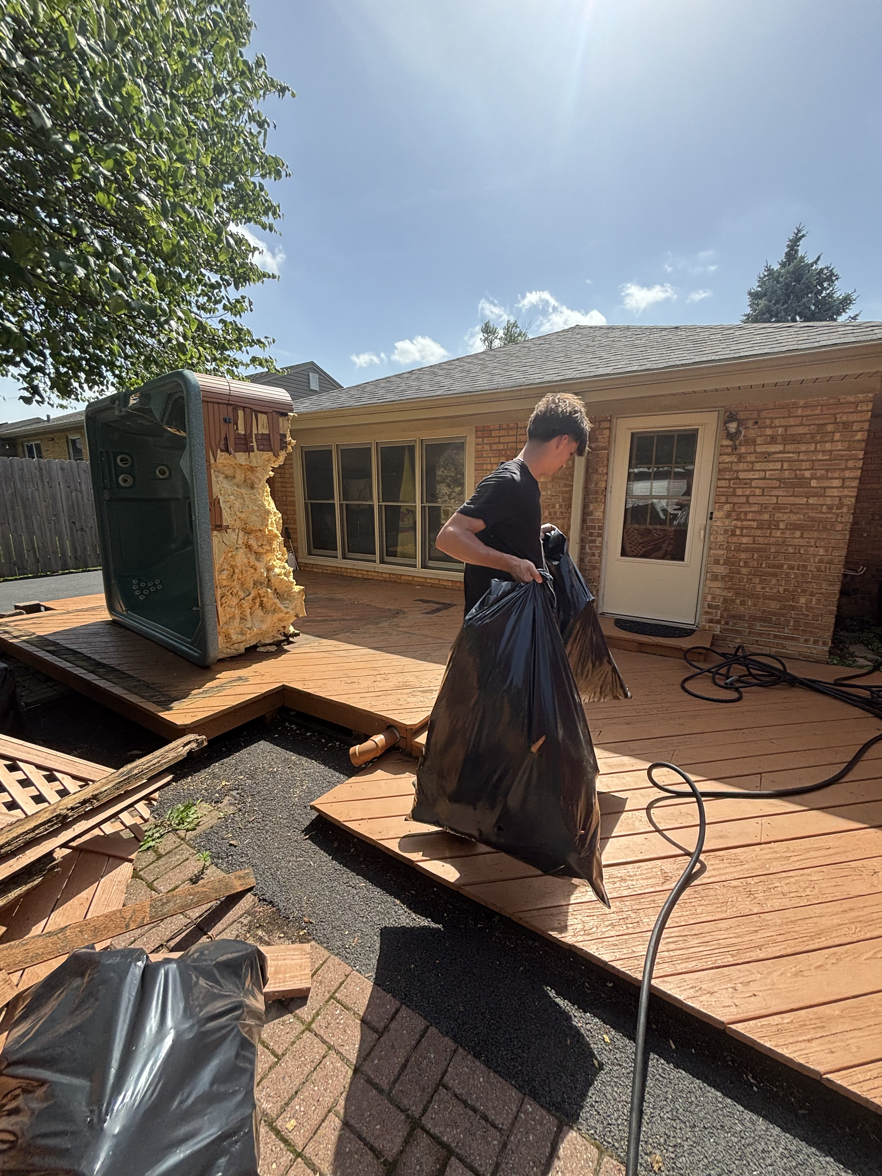 Collecting demo debris from deck for haul-away