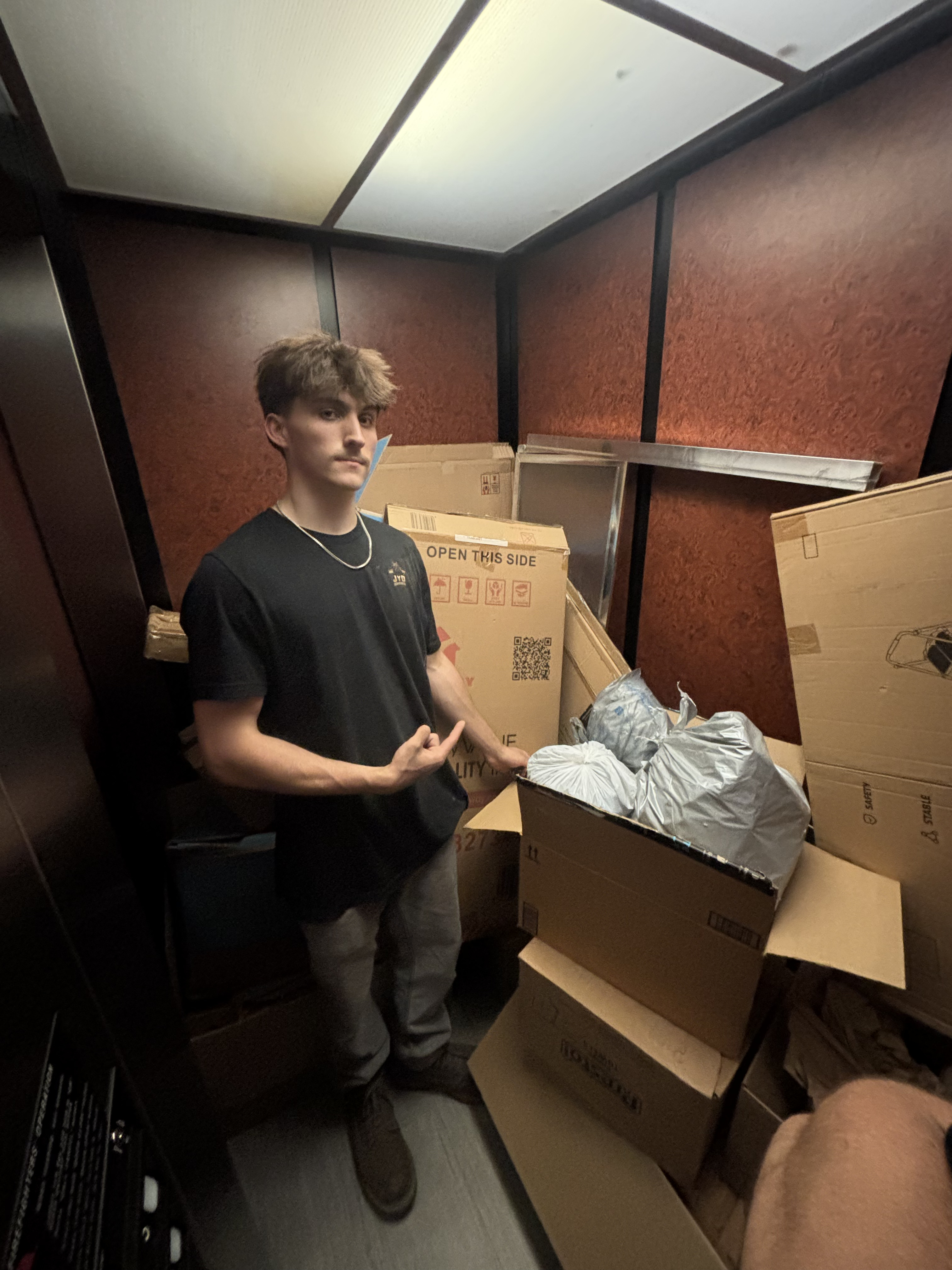 Loading boxes onto elevator for estate removal job