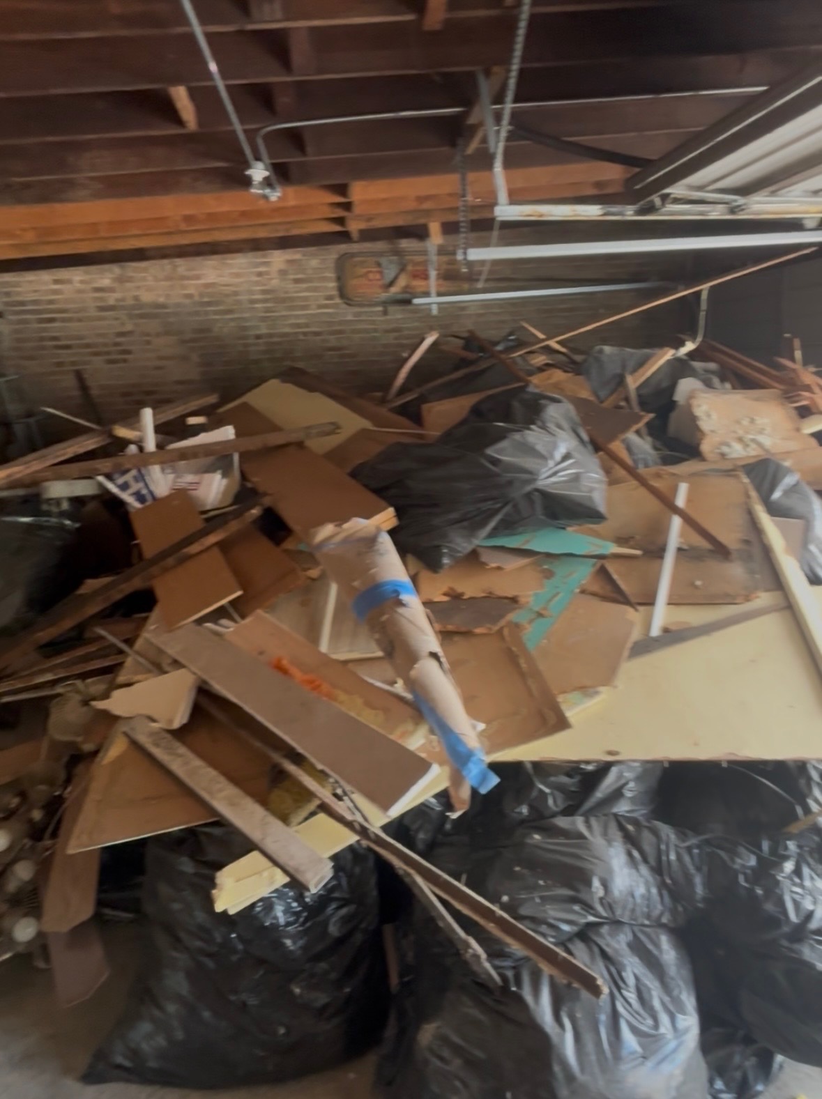 Garage packed with debris and cardboard — before cleanout
