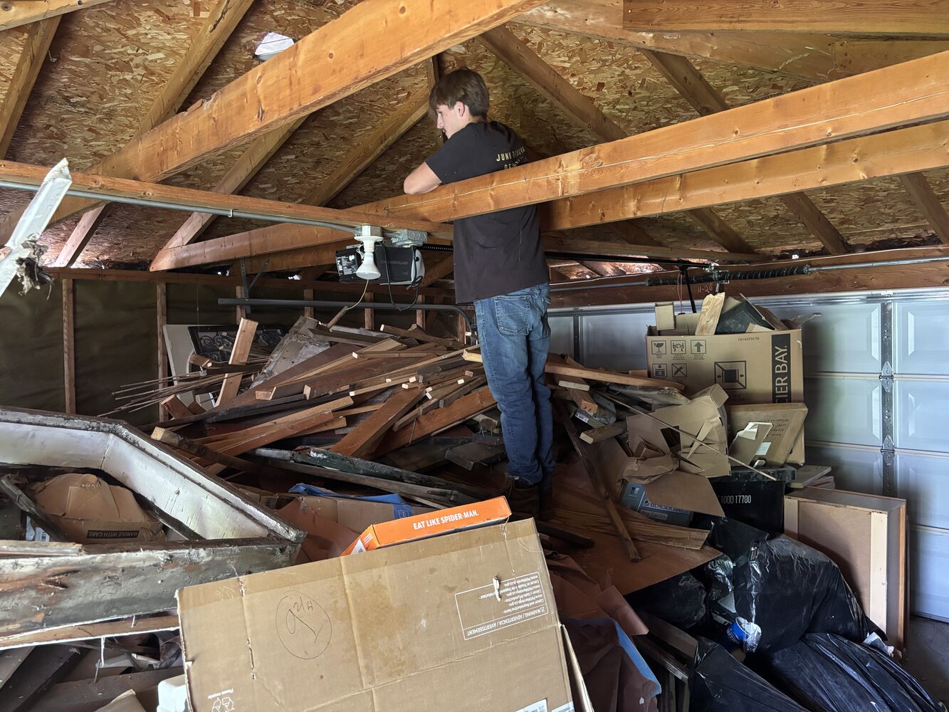 JYD Services Co. crew clearing a garage packed with demolition debris
