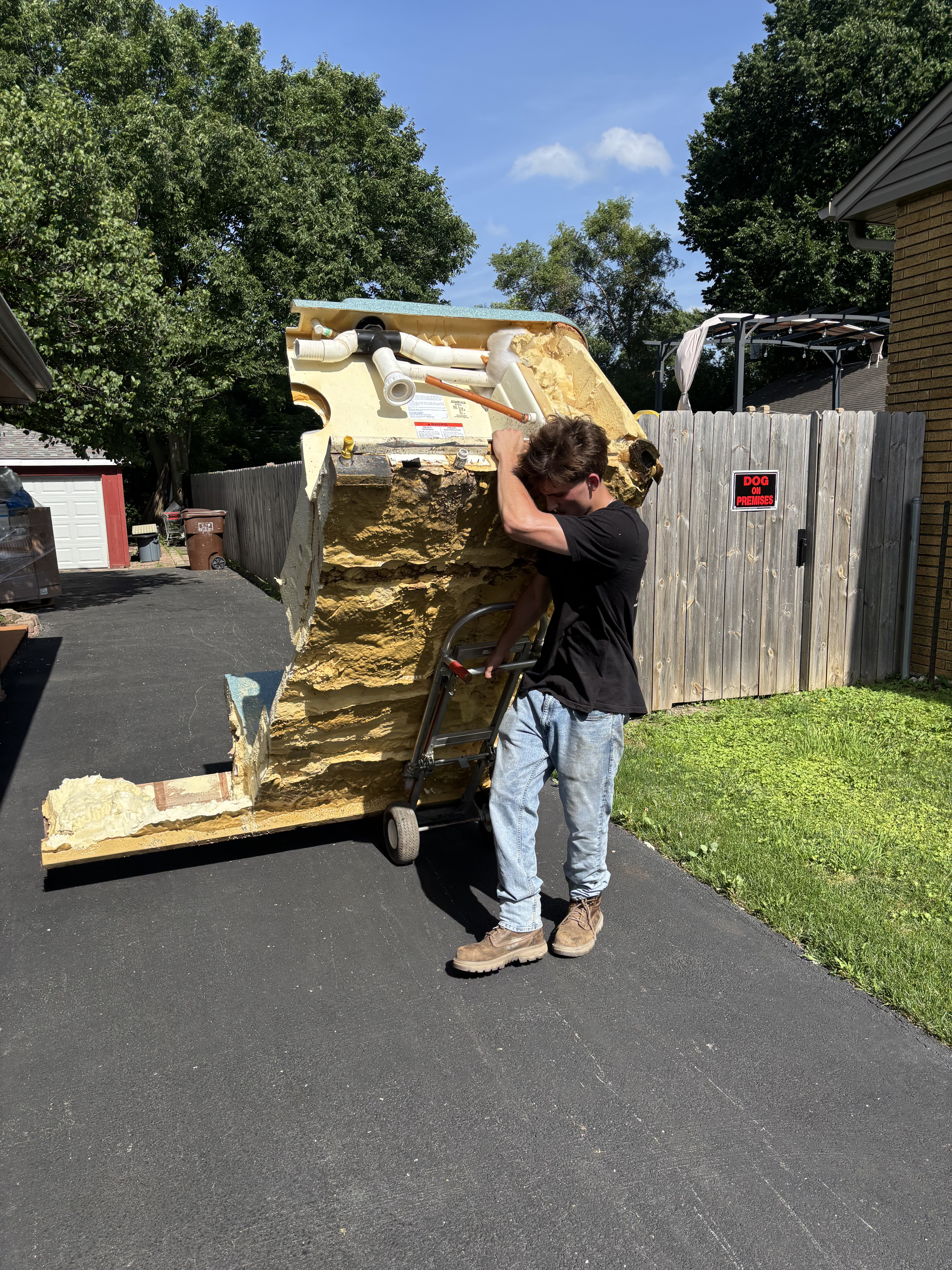 Worker carrying large insulation piece out to the trailer