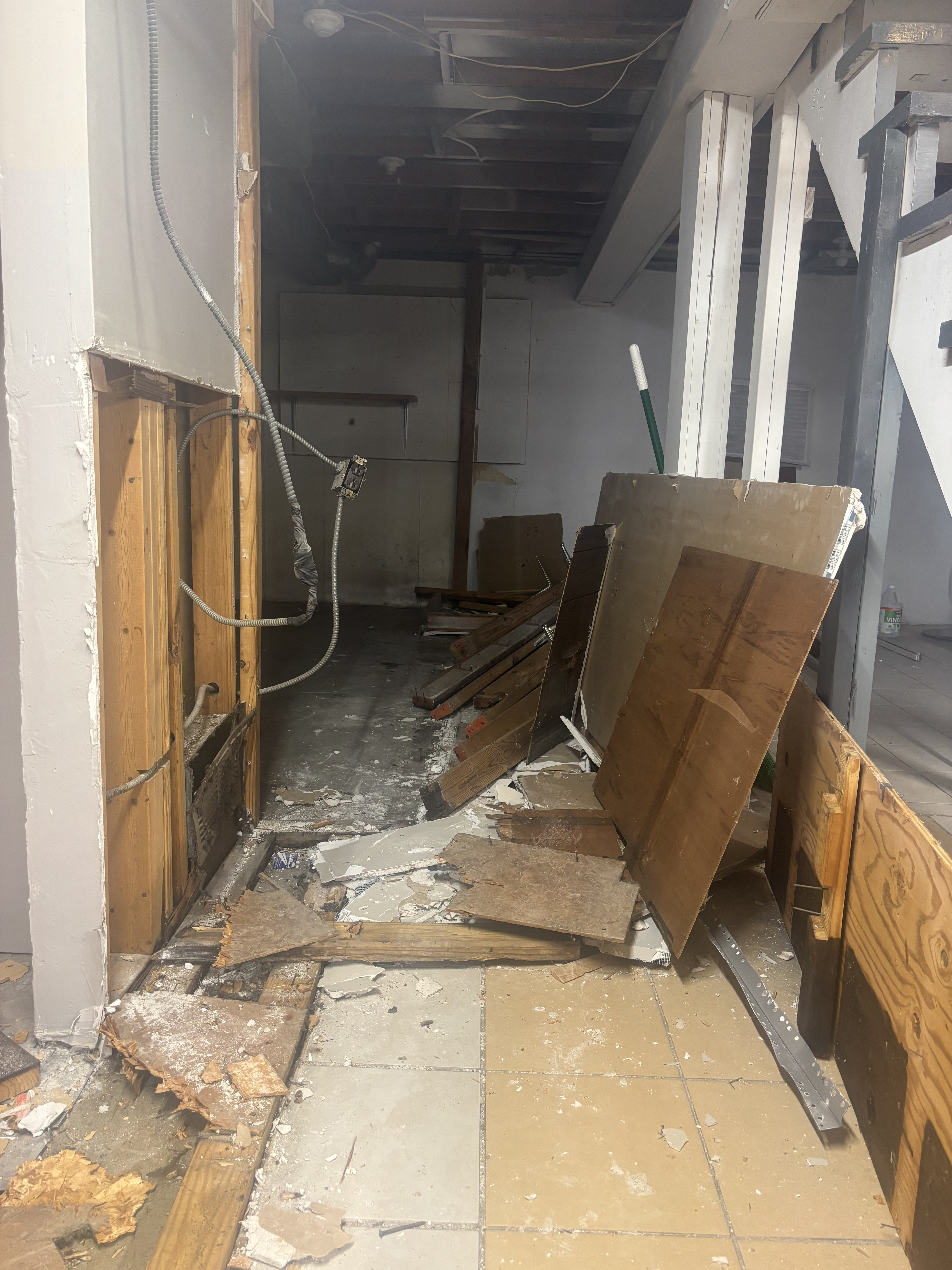 Interior commercial demolition with stripped walls and debris