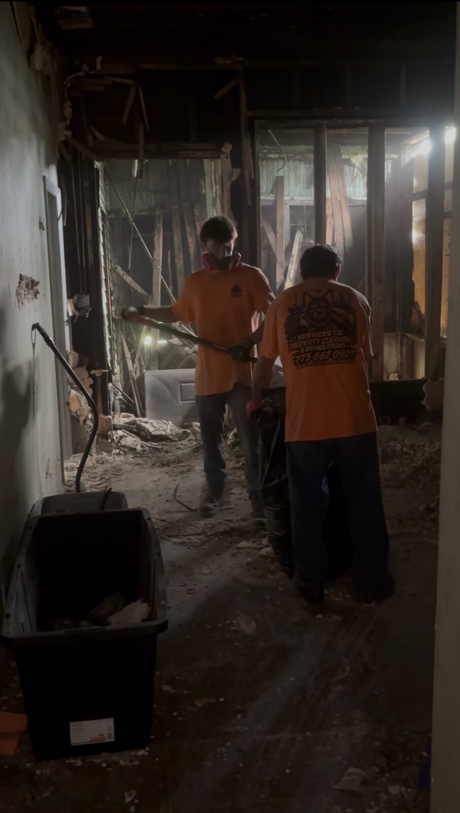 JYD Services demolition crew removing debris from a stripped interior