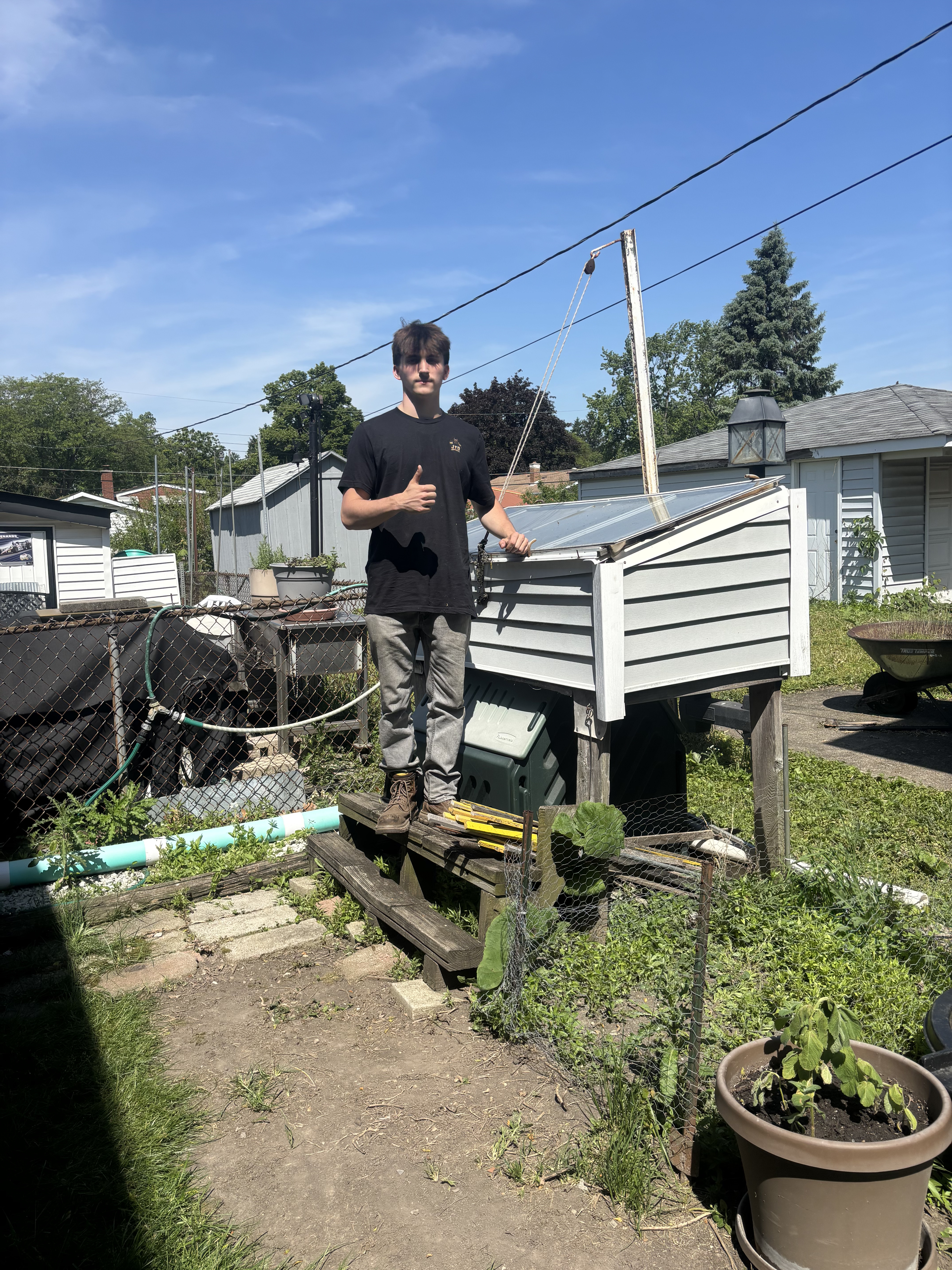 Worker preparing a backyard shed for demolition and removal