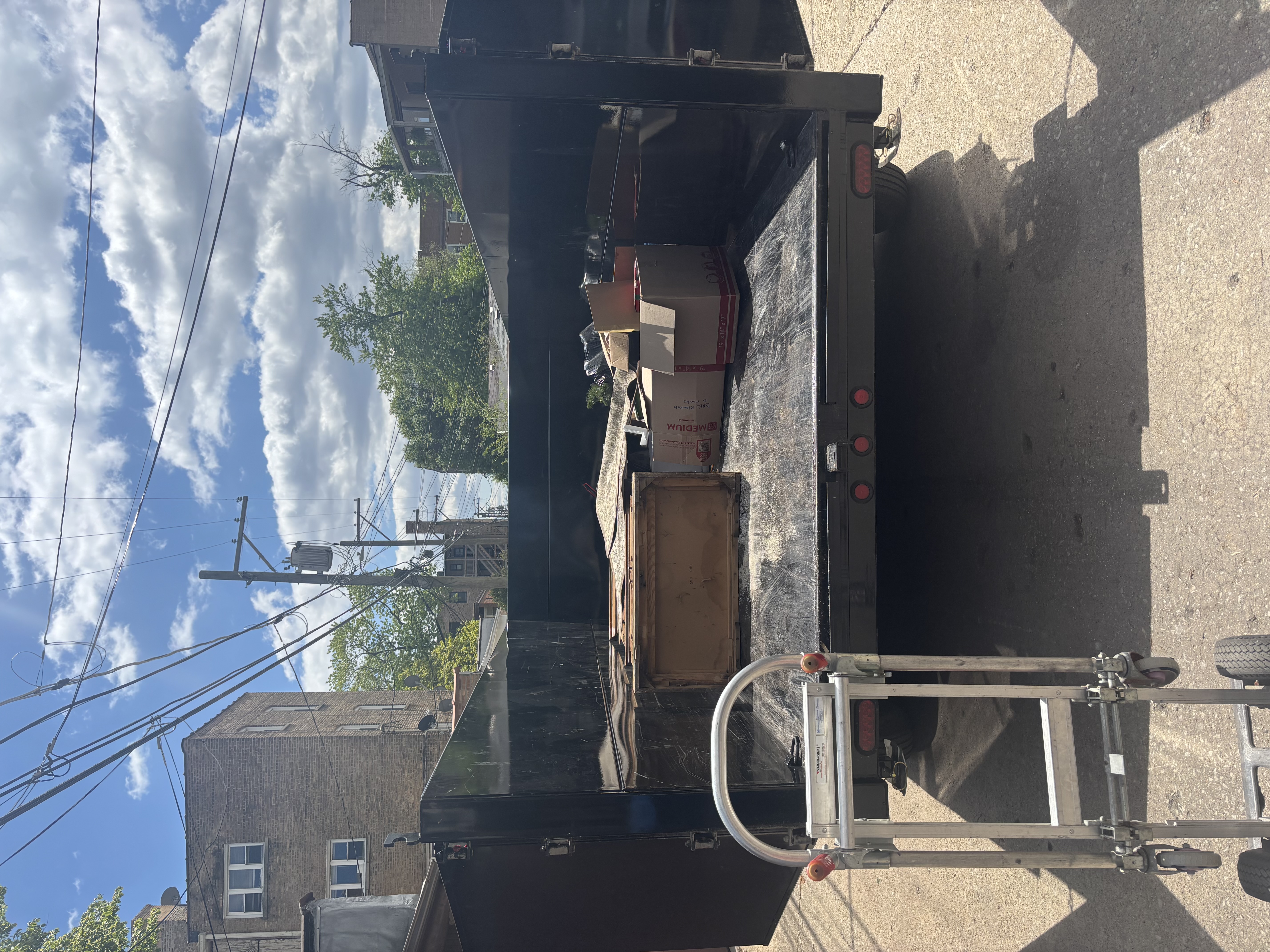 Trailer loaded with piano and debris ready for haul-away